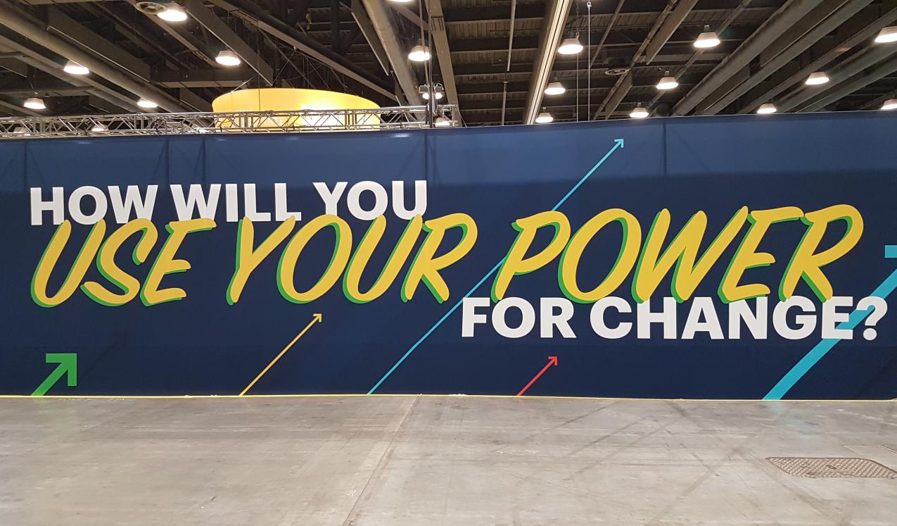 A banner at the conference asking "how will you use your power?"