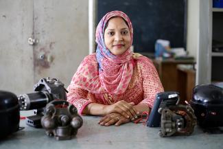 Shirina Akter with refrigeration machinery she teaches with in her classroom at UCEP school, Dhaka, Bangladesh ©UKAID