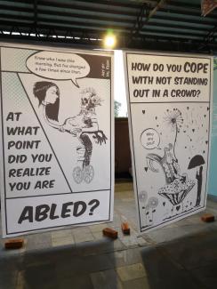 A sign at the conference with a picture of someone in a wheelchair reads "At what point did you realise you were abled?"