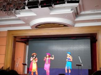 Presenters dressed as cowgirls on stage