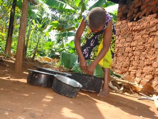 A girl preparing food in Uganda. Credit: Plan International Uganda