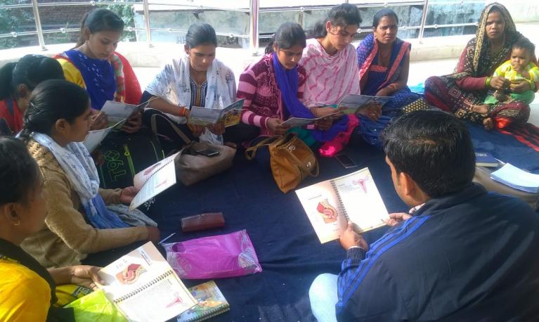 Village mentors preparing for group education session with adolescent girls, using the based on PAnKH Diary, in Dholpur, Rajasthan, India. © ICRW