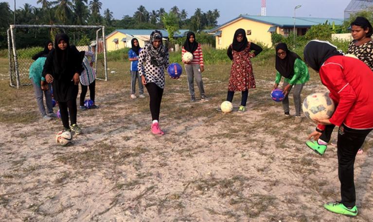 Young women practice their skills on the soccer field. Photo © World Bank