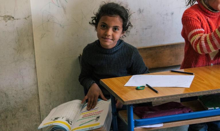 Before the pandemic, a refugee girl studies at a school in Lebanon supported by the Luminos Fund. © Luminos Fund