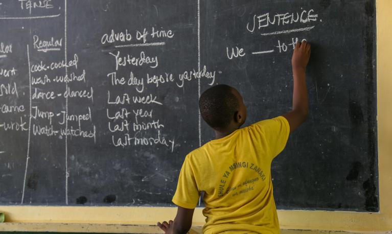 At student writing on a board. © Sarah Farhat / World Bank ID: 20170317-Tanzania-Farhat-8282