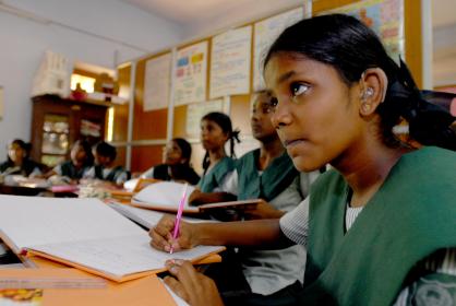 A girl with a hearing aid amongst peers at a school in Chennai, India. © Pippa Ranger/Department for International Development