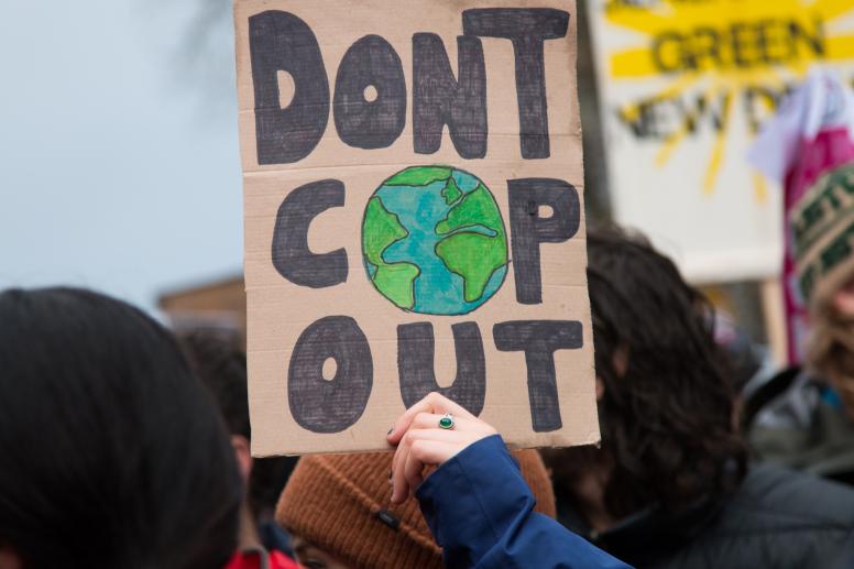 Demonstrators raise placards at one of the protests outside COP26 in Glasgow, November 2021 ©Toby Parkes/Shutterstock/2070571724