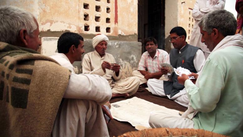 Men playing cards in their community. A scene from the documentary film, A Fine Balance (2015), produced by ICRW and directed by Sanjay Barnela. ©ICRW