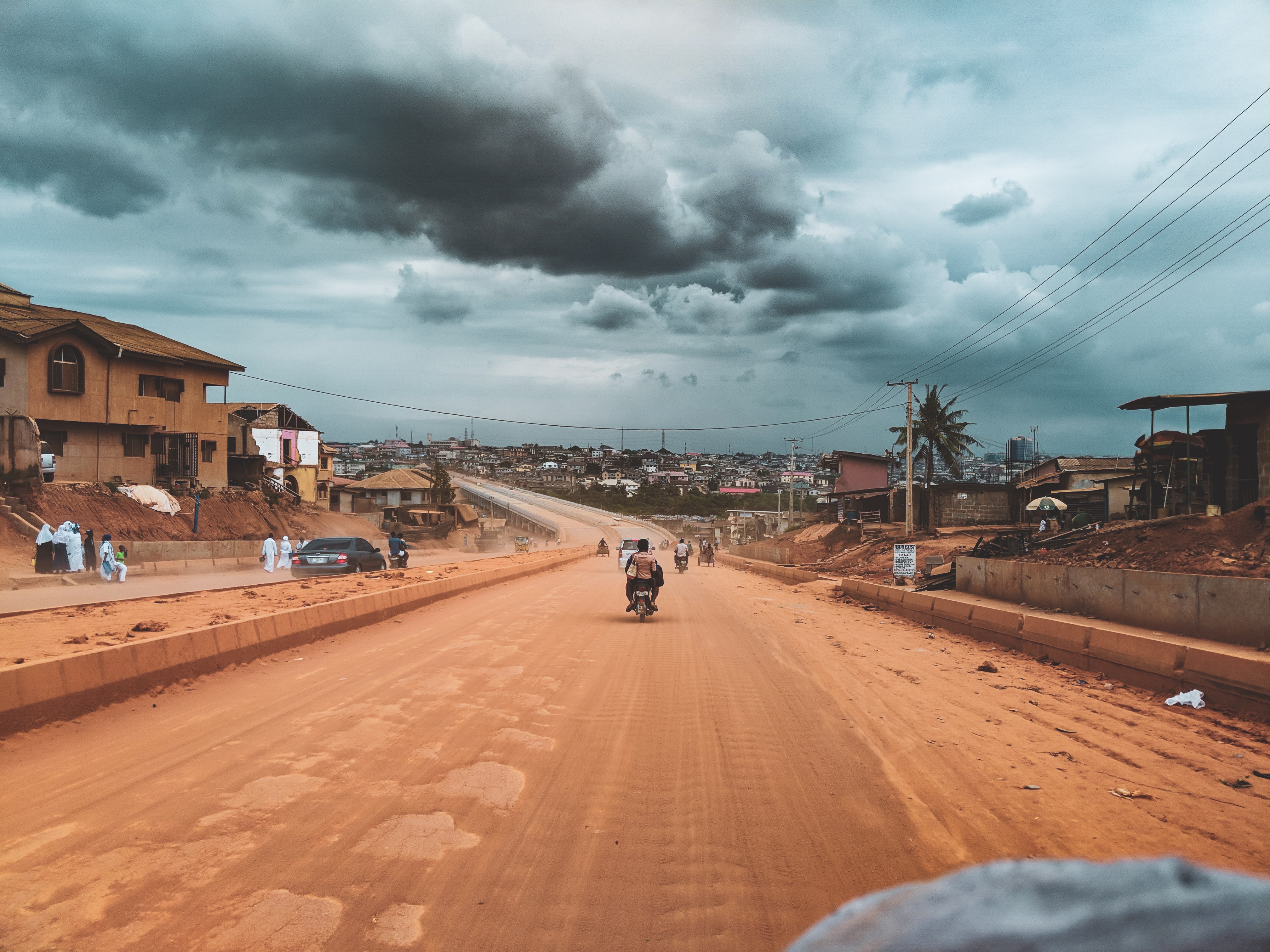 Dirt road in Nigeria with fellow commuters and community members.