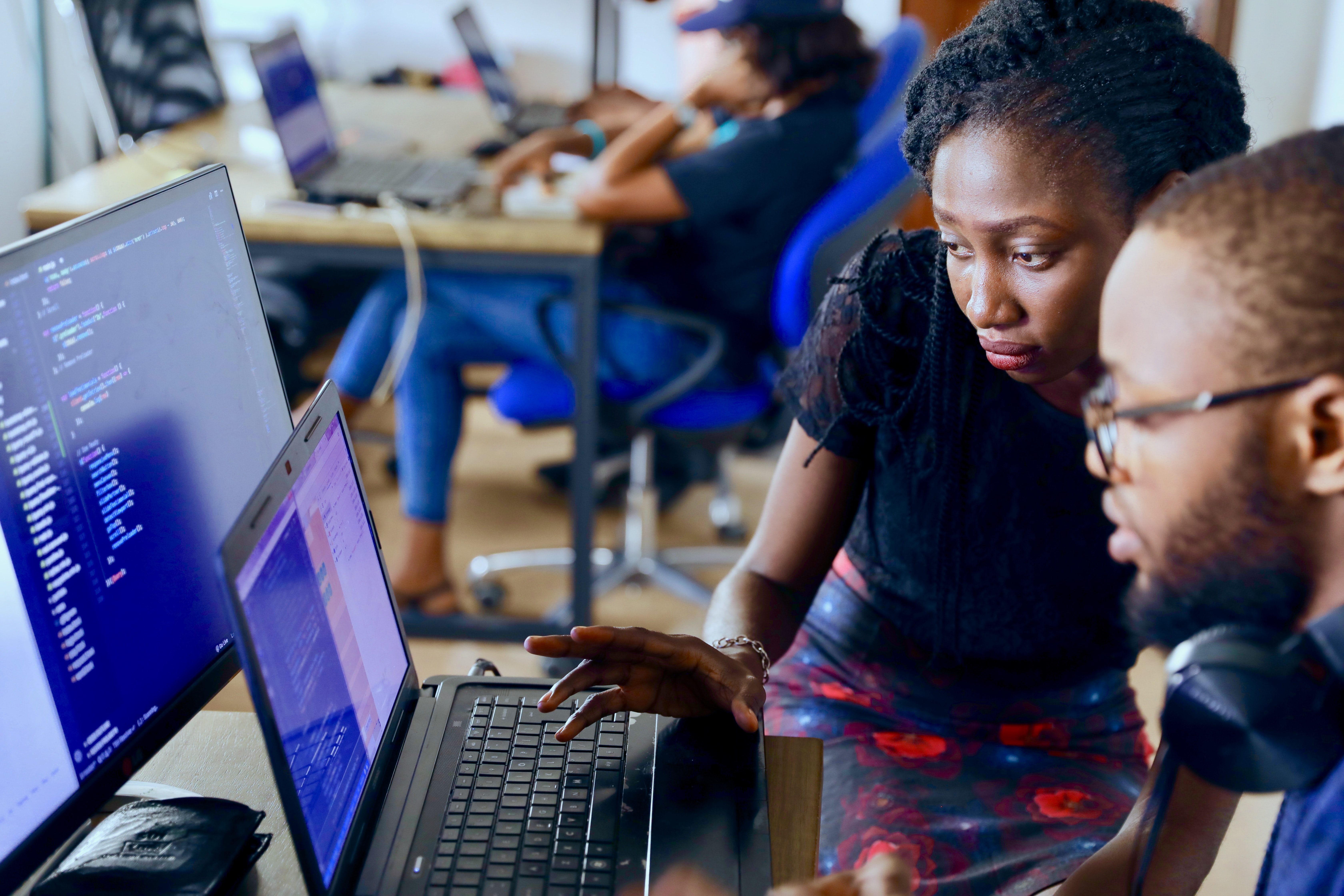 Image of two individuals looking at a computer screen together