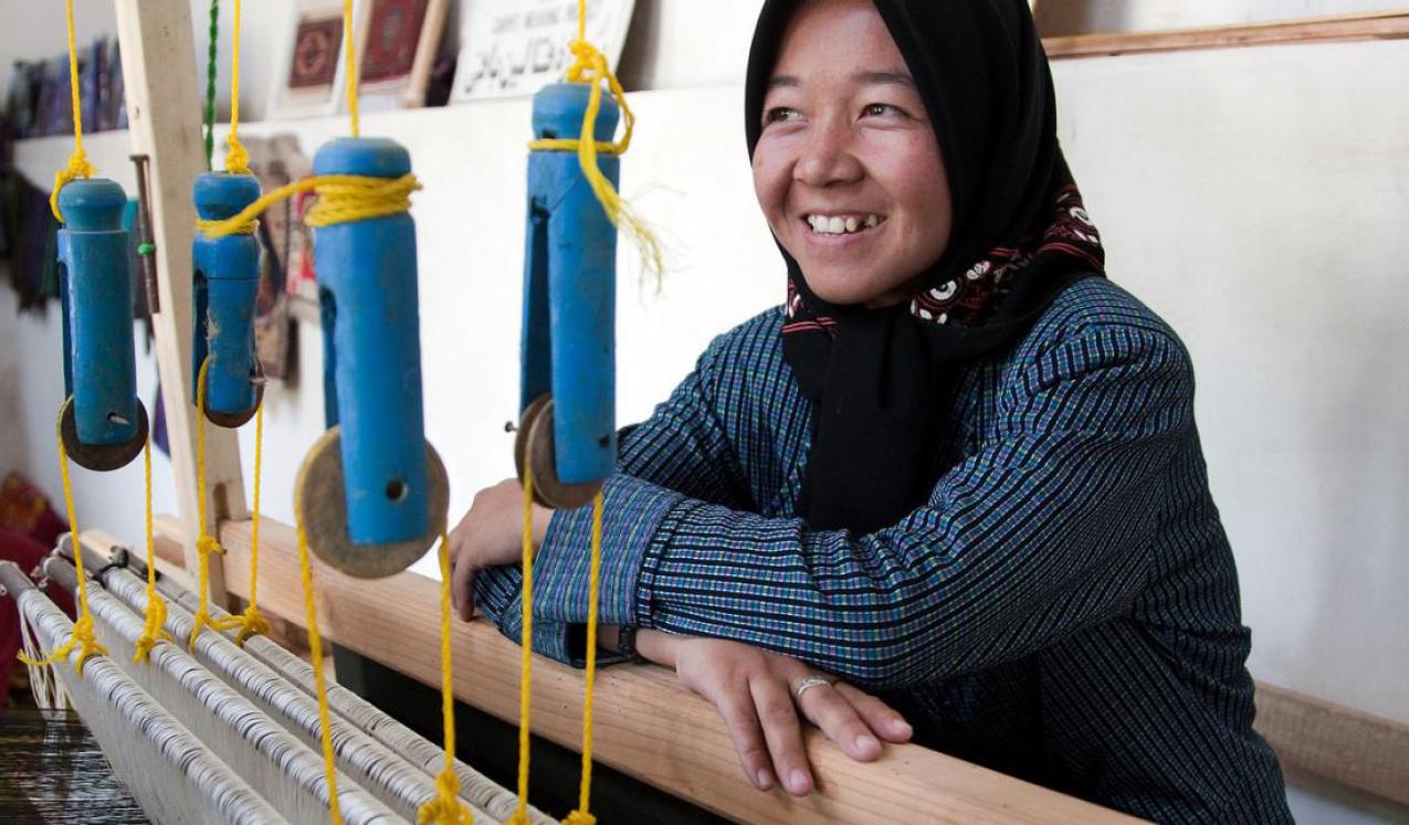 Sughira, 16-years-old, works at weaving silk on a loom at a carpet and silk weaving centre in Herat Citadel Afghanistan. Copyright: World bank