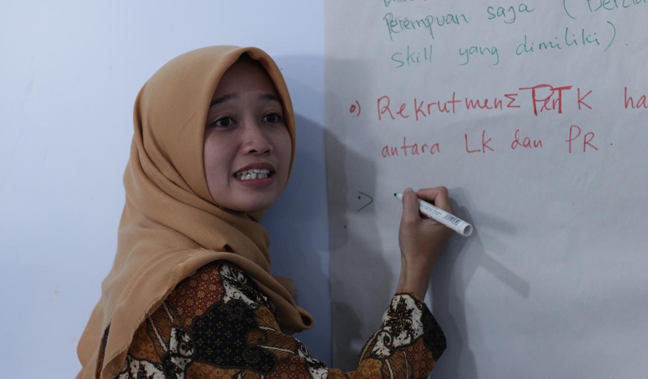 A woman taking notes at the convening