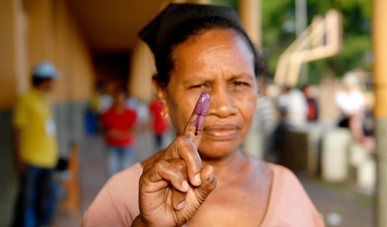 A woman holds up her stained finger after voting today in Timor-Leste's presidential run-off poll . © UN Photo/Bernardino