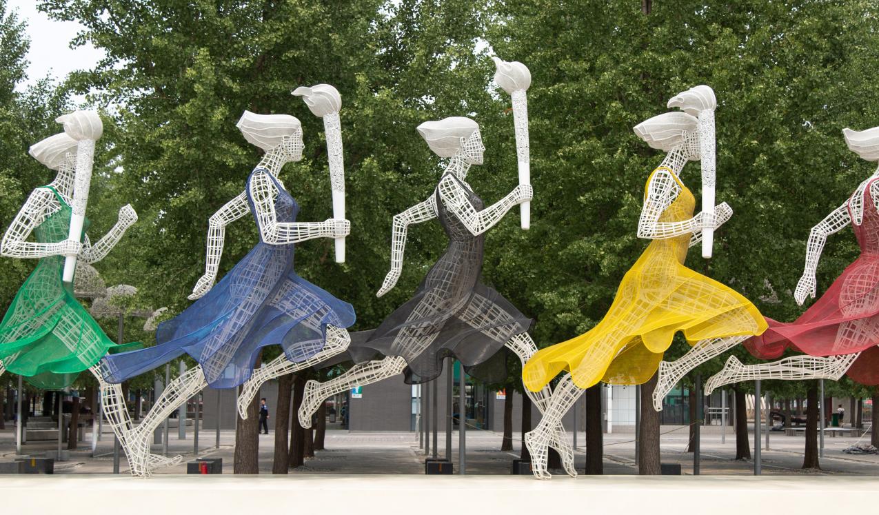 Sculptures of women running with Olympic torches in Beijing, China. © Sam Balye/Unsplash