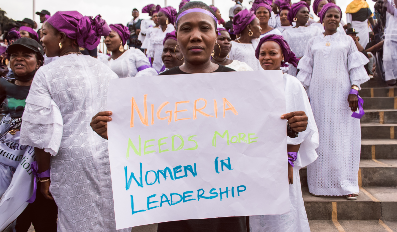 A woman at a protest rally in response to the government's rejection of a gender equality bill, holds a sign saying 'Nigeria needs more women in leadership'. Lagos, Nigeria, March 2022. © Tolu Owoeye | Shutterstock ID: 2150255371