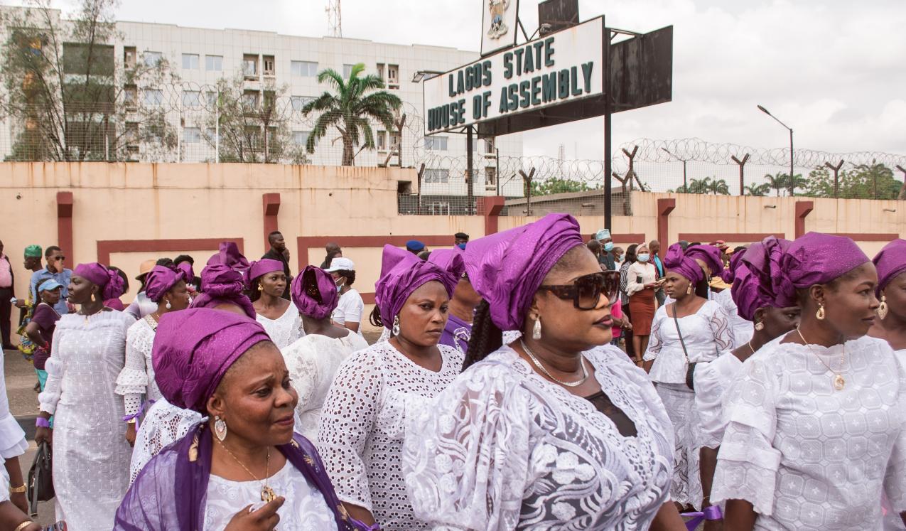 Women wearing purple and white outfits at a protest rally in response to the government's rejection of a gender equality bill.  Lagos, Nigeria, March 2022. © Tolu Owoeye | Shutterstock ID: 2150255357
