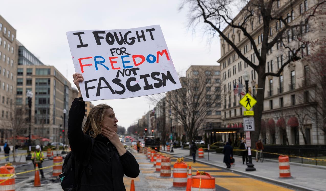 Protesters near the White House in Washington, D.C., USA, as street murals as dismantled behind. 14 March 2025. © Ashish Kiphayat | Shutterstock ID: 2615314669