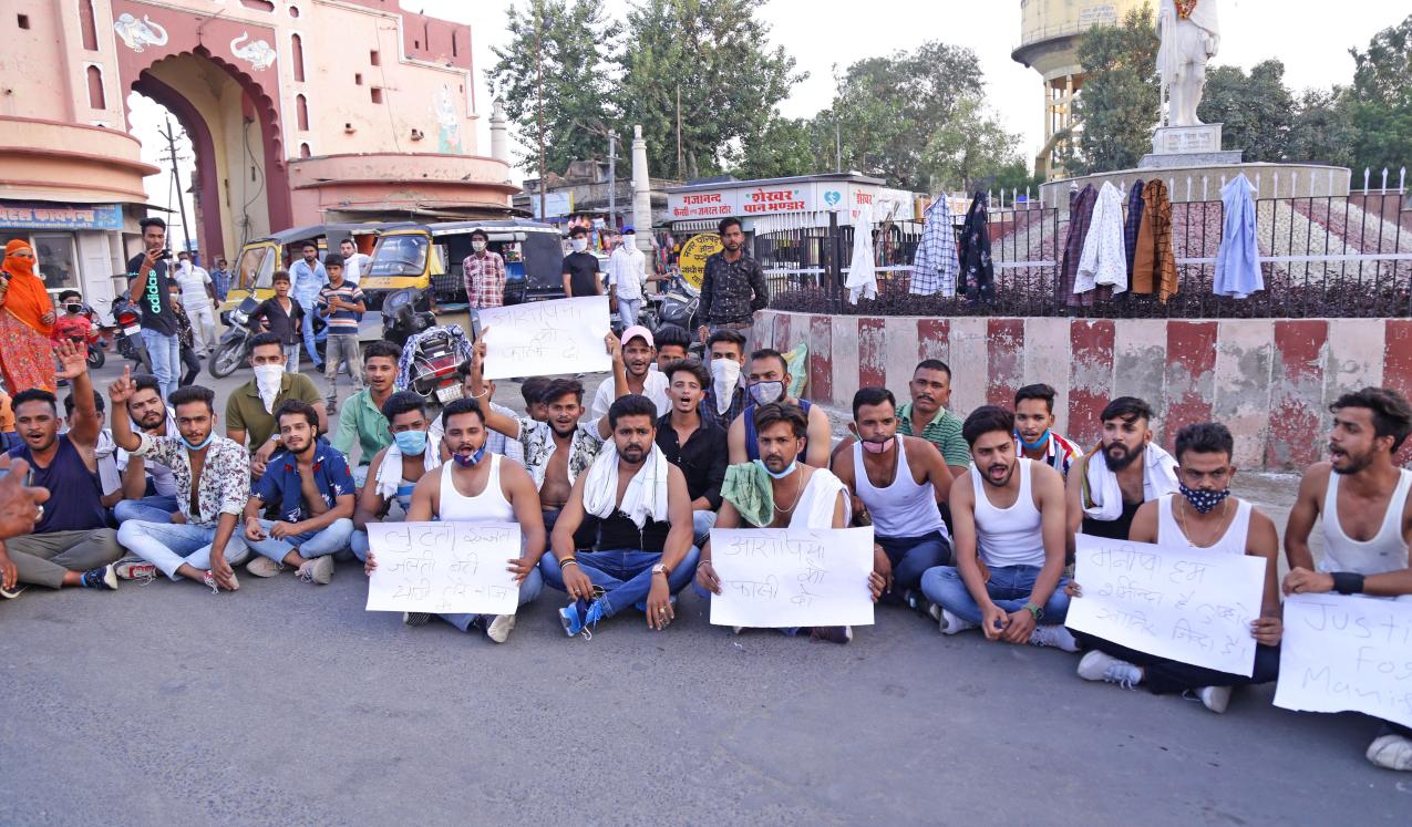 Congress party workers raise slogans at a protest against the death of a 19-year-old Dalit woman who was allegedly gang-raped in Uttar Pradesh's Hathras. One sign reads: ‘punish the perpetrator’. Beawar, India, 2020. © Sumit Saraswat/Shutterstock.com