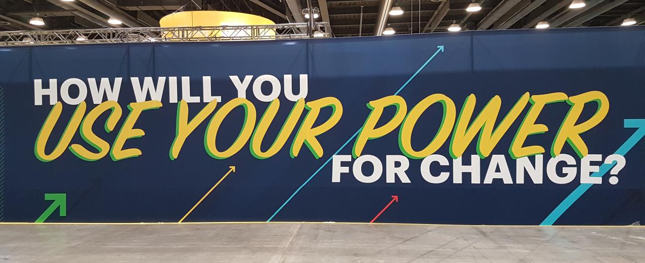A banner at the conference asking "how will you use your power?"
