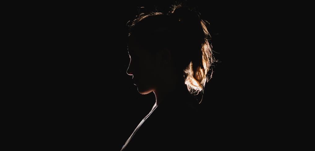 Silhouette of a woman. Photo by Molly Belle on Unsplash