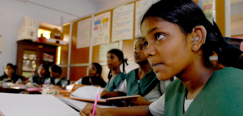 A girl with a hearing aid amongst peers at a school in Chennai, India. © Pippa Ranger/Department for International Development