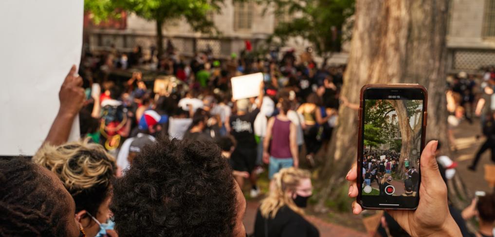 A person records protesters with their phone in Washington, DC / United States. © Jackson Fox-Bland/shutterstock