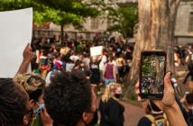 A person records protesters with their phone in Washington, DC / United States. © Jackson Fox-Bland/shutterstock