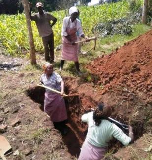 Women digging graves. © Saint Albert's Charity