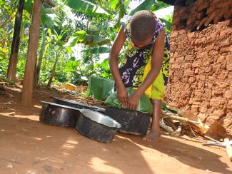 A girl preparing food in Uganda. Credit: Plan International Uganda