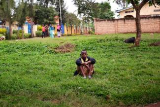 Young boys from the village sat nearby listening