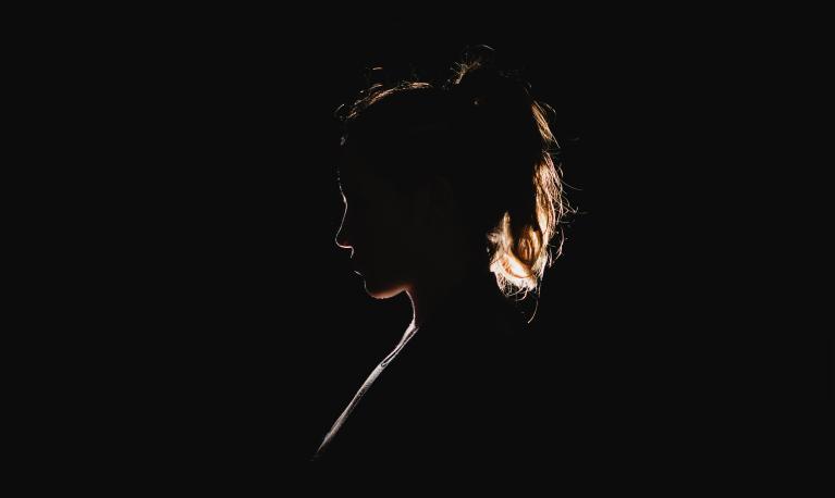 Silhoutte of a woman. Photo by Molly Belle on Unsplash