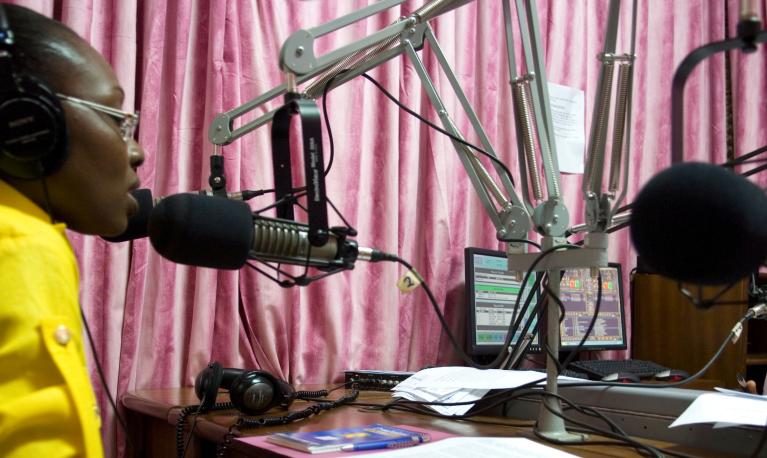 Morning radio show host Komla Dumor works in his sound booth at the Joy FM studio in Accra, Ghana. © Jonathan Ernst / World Bank