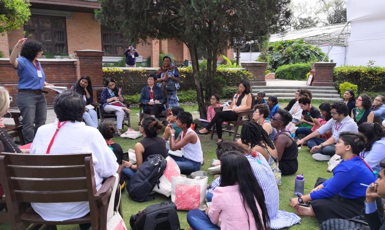 Participants sit outside at the conference