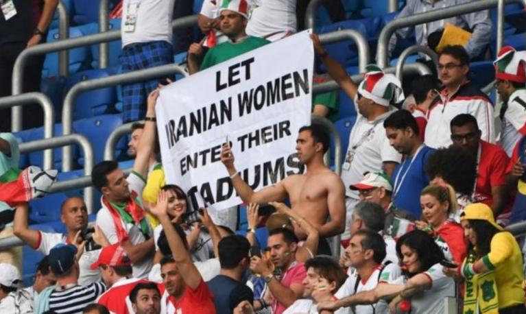 Fans hold up a sign supporting women at stadiums. © Getty Images/BBC