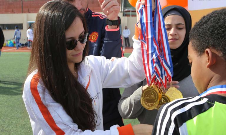 Sarah El Jizi, head coach in the Beirut area for Right To Play, hands out football medals at Nahr el-Bared refugee camp in northern Lebanon. Photograph: Maher Hasbany/Courtesy of Right To Play