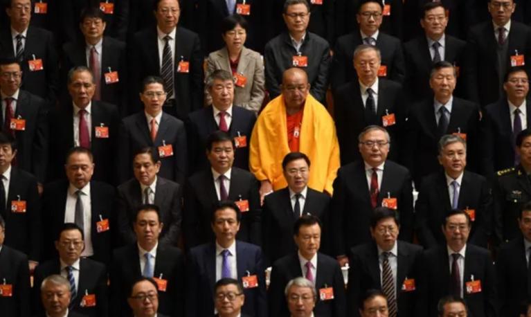 A lone woman is seen among delegates at the National People’s Congress in Beijing. © Fred Dufour/AFP/Getty Images