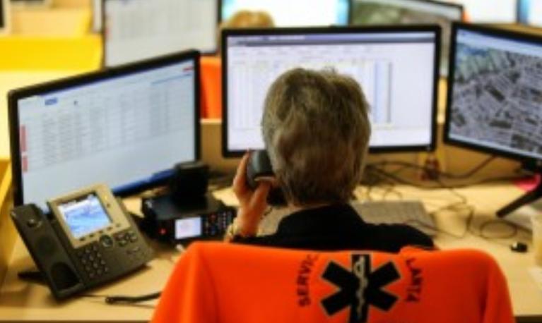 A woman in a police jacket works at a call center © Adobe Stock via Center for Global Development