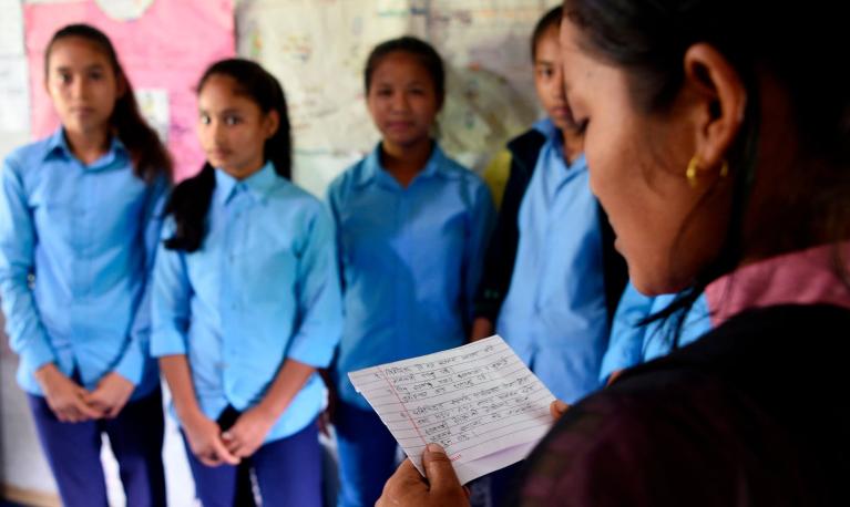 Asha Charti Karki (R), who got married at 16, mentors young girls in Surkhet district, Nepal. © Prakash Mathema/AFP via Getty Images