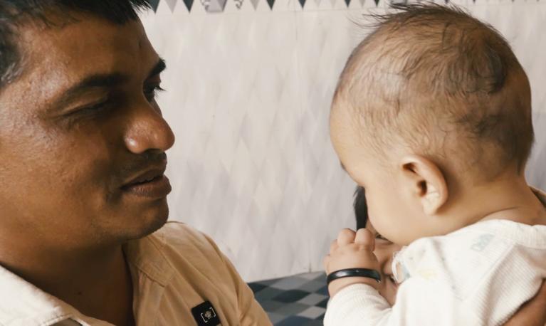 A family spending time with their child. A scene from the documentary film, Parwaaz | Flight (2020), produced by ICRW and directed by Mixed Media Productions © ICRW