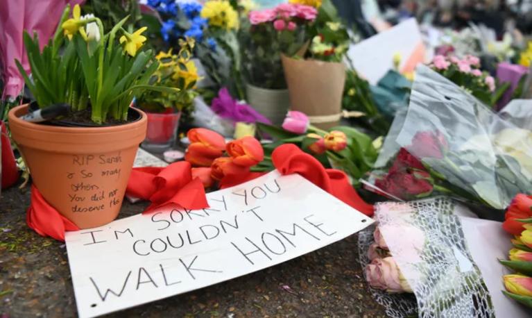 Flowers laid in memory of Sarah Everard with messages highlighting how the threat of violence undermines simple tasks like walking home. EPA/Andy Rain