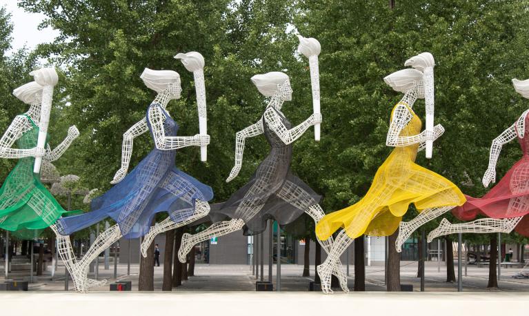 Sculptures of women running with Olympic torches in Beijing, China. © Sam Balye/Unsplash