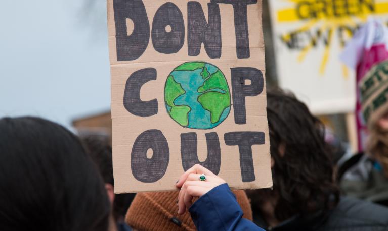 Demonstrators raise placards at one of the protests outside COP26 in Glasgow, November 2021 ©Toby Parkes/Shutterstock/2070571724