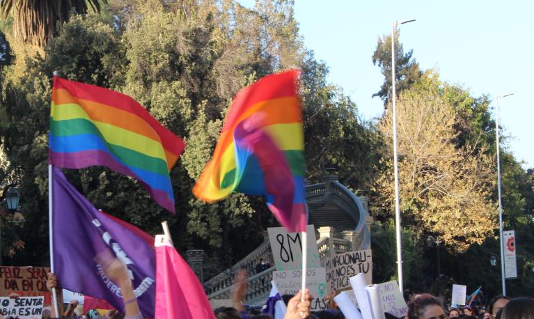 LGBTQ flags fly at a 8M march in Santiago, Chile