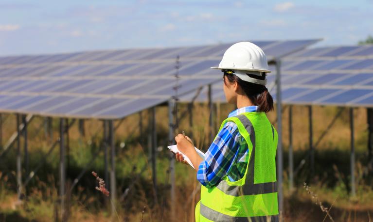 A young woman engineer checking solar panel at solar power plant © Monthira | Shutterstock ID: 786784237