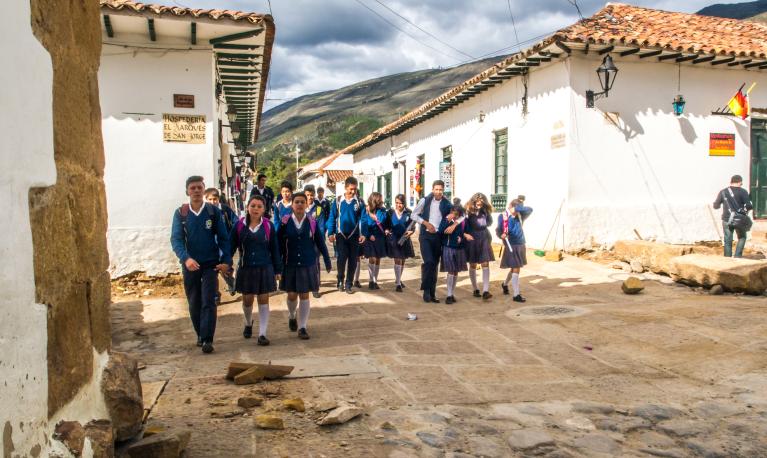 Children in school uniforms going to school in Villa de Leyva, Colombia. © Nowaczyk | Shutterstock ID: 1355817296
