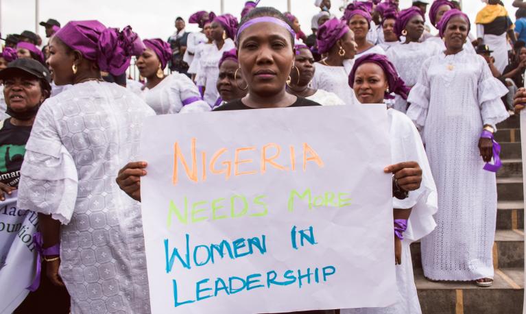 A woman at a protest rally in response to the government's rejection of a gender equality bill, holds a sign saying 'Nigeria needs more women in leadership'. Lagos, Nigeria, March 2022. © Tolu Owoeye | Shutterstock ID: 2150255371