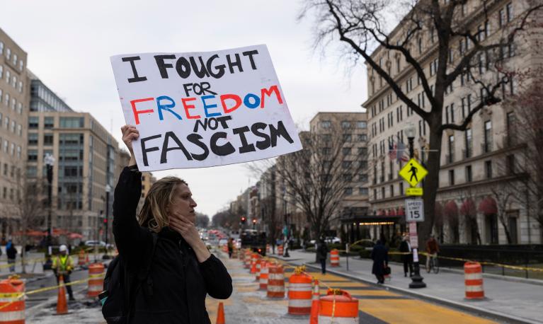 Protesters near the White House in Washington, D.C., USA, as street murals as dismantled behind. 14 March 2025. © Ashish Kiphayat | Shutterstock ID: 2615314669