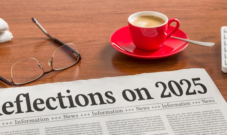 A newspaper on a wooden desk - Reflections on 2025 © Zerbor | Shutterstock ID: 2707617607