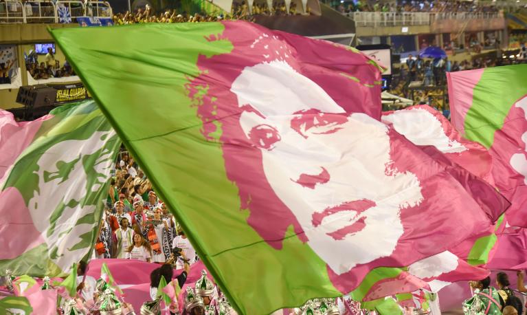Flags of murdered Brazilian politician, Marielle Franco, waved during the Rio de Janeiro Carnival. Brazil, 2019. © Shutter Photo Press | Shutterstock