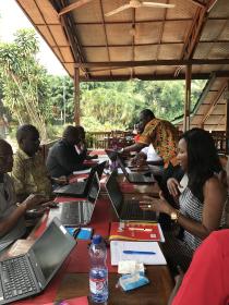 Community members meet in a small group during an in-person meeting. 